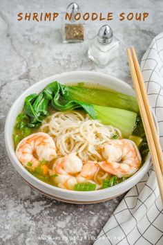 shrimp noodle soup in a white bowl with chopsticks on the side and text overlay that reads shrimp noodle soup