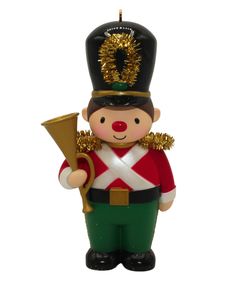 a christmas ornament with a nutcracker holding a trombone in its hand