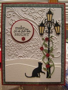 a card with a cat sitting next to a lamp post