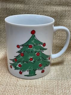 a coffee mug with a christmas tree painted on it