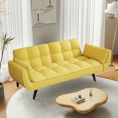 a living room with a yellow couch and coffee table