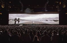 a large screen in the middle of a concert hall