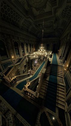 an ornate building with stairs and chandelier in the center is lit up at night