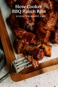 slow cooker bbq ranch ribs on a cutting board with a fork