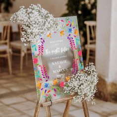 the welcome sign is decorated with baby's breath flowers and baby's breath