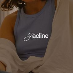 a woman wearing a tank top with the word facline on it's chest