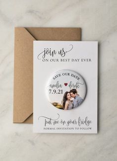 a wedding save the date magnet on top of a card