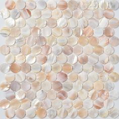 an image of a white and pink mosaic tile with circles on the bottom, in shades of