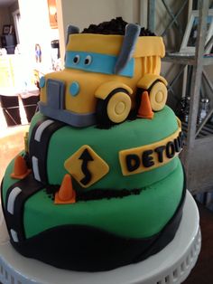 there is a cake made to look like a construction truck on top of the cake