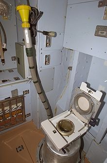 a toilet that is in the middle of some kind of room with wires attached to it