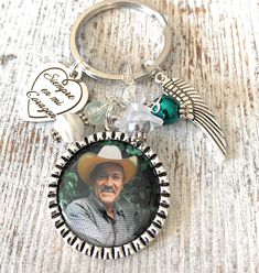 a keychain with an image of a man wearing a cowboy hat on it