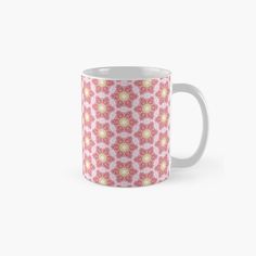 a pink and yellow flower pattern on a white background classic mug