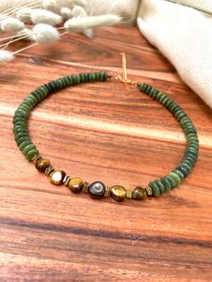 Elevate your style with our chunky beaded choker necklace, a captivating blend of natural beauty and boho chic elegance. This stunning necklace measures 14.5 inches in length and features a 2.75-inch adjustable extender, allowing you to find your perfect fit. The necklace is fully beaded with a harmonious mix of 4mm tigers eye, olive jade rondelle beads, 8mm tigers eye nugget beads, and square hematite accents. The majority of the design showcases beautiful olive green hues, transitioning gracef Gemstone Choker Necklace, Jade Bead Necklace, Gemstone Choker, Tigers Eye Necklace, Evil Eye Earrings, Bridal Earrings Pearl, Crystal Dangle Earrings, Tigers Eye Gemstone, Tiger Eye Beads