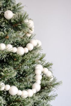 a christmas tree with white balls hanging from it