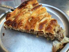 a piece of pie sitting on top of a metal plate