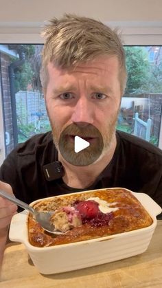 a man holding a spoon in front of a dish