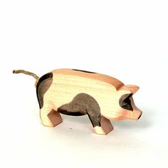 a small wooden pig toy on a white background