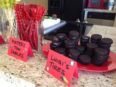 some cookies are on a red plate and there is a sign that says liners tires