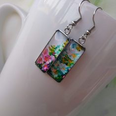 Vibrant Flowers Art Pattern Painting Handmade Glass Jewelry Hook Earrings Artistic bold statement earrings, a perfect gift and choice for any occasion. Ideal gift for an artist. Chic and Unique. Measures 25 mm in length and 10 mm in width. Comes with First Class Free shipping. Colors may vary due to monitor and lighting differences. Colorful Hand Painted Earrings As Gift, Colorful Hand Painted Earrings For Gift, Hand Painted Colorful Earrings For Gifts, Artistic Green Earrings For Gift, Colorful Drop Earrings As A Gift, Artistic Flower-shaped Earrings For Gifts, Colorful Artsy Earrings For Gift, Colorful Artistic Jewelry For Gifts, Artistic Colorful Jewelry For Gifts