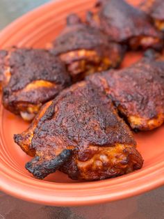 some meat is sitting on an orange plate