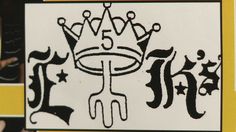 a close up of a sign with the word king written on it and a crown in the middle