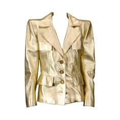 Iconic YSL Jacket in Gold kid leather with extreme pagoda shoulders circa 1985. Gilt Bronze flowerhead buttons by Goosens. Black silk charmeuse lining. Crafted by YSL Haute Couture. Iconic is an often used term. This jacket is testament to the power chic of the 1980's jet set. Ex Collection: Fashion Icon Tina Chow See "Flair:Fashion Collected by Tina Chow" Richard Martin,Harold Koda, Rizzoli Pg.138-139 Size 6-8 US Ysl Haute Couture, Gold Leather Jacket, Celebrities Leather Jacket, 80s Jacket, Gold Jacket, Cashmere Jacket, Couture Jackets, French Fashion Designers, Real Leather Jacket