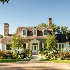 a large house with lots of windows and landscaping