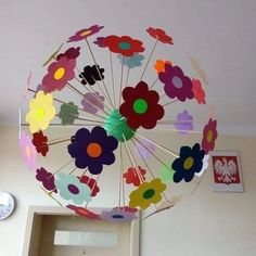 a paper flower umbrella hanging from the ceiling