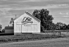 black and white photograph of an old barn