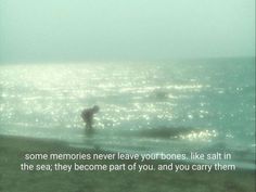 two people standing in the ocean on a foggy day with a quote written below