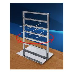 a metal rack with three shelves and two red arrows pointing to the bottom of it