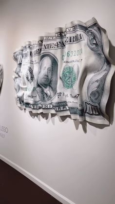 two dollars are hanging on the wall next to each other