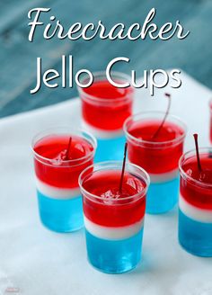 red, white and blue jello cups with toothpicks in them on a napkin