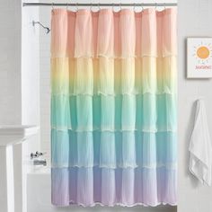 a bathroom with a shower curtain that is multicolored