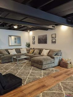 a living room with couches and rugs on the floor