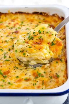 a spoonful of mashed potato casserole in a blue and white dish