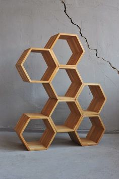 a wooden shelving unit with hexagonal shelves