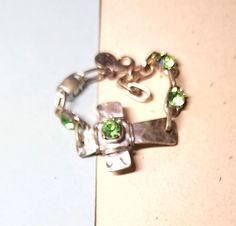 This is a for a vintage, chunky green cross with green beads  bracelet. This is in good condition, and is unsigned with no markings. It has not been cleaned and has usual wear and tear for the age. The photos don't always depict the true color. I took several pictures so you could see clearly the condition they are in. This is a used item and sold as is. If you have any problems with an item please message me. I will do my best to work with customers about any issues you may have. I sell an item as is, so items are many times imperfect. This item has free shipping. Adjustable Green Costume Jewelry Bracelets, Handmade Green Cross Jewelry, Vintage Green Sterling Silver Bracelets, Unique Adjustable Cross Jewelry, Green Metal Costume Jewelry Bracelet, Green Metal Costume Jewelry Bracelets, Green Metal Bracelet Costume Jewelry, Adjustable Unique Cross Jewelry, Green Metal Bracelets For Costume Jewelry