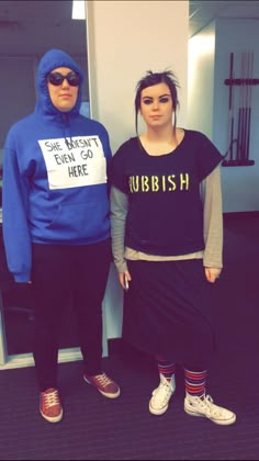 two people dressed up in costumes standing next to each other, one wearing a blue hoodie