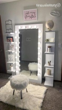 a room with a mirror, stool and lights on the wall above it in front of a bookcase