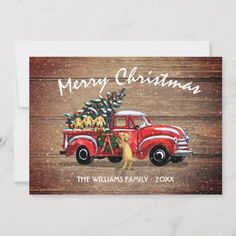 a christmas card with an old red truck and dog carrying a tree on the back