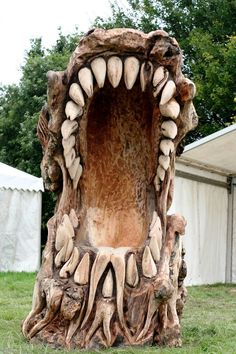 a sculpture made out of wood with teeth on it