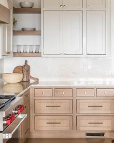 a kitchen with wooden cabinets and white counter tops