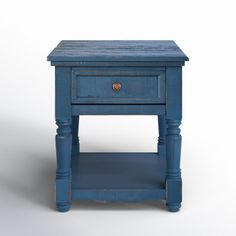 a small blue table with one drawer on the top and two drawers on the bottom