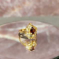 Step back in time with our exquisite Vintage 10k Gold Freeform Ring, featuring a mesmerizing Pear Cut Garnet. This timeless piece of fine jewelry exudes elegance and charm, perfect for adding a touch of vintage glamour to any ensemble. Crafted with care and attention to detail, this ring boasts a unique freeform design that sets it apart from the ordinary. The lustrous 10k gold band adds a luxurious touch, while the pear-cut garnet gemstone sparkles with rich hues of red, reminiscent of a deep s Luxury Pear-shaped Ruby Ring For Formal Occasions, Elegant Pear-shaped Yellow Gold Birthstone Ring, Elegant 14k Gold Diamond Cut Topaz Ring, Teardrop Gemstone Ring For Formal Occasions, Classic Pear-shaped Topaz Ring For Formal Occasions, Classic Formal Pear-shaped Topaz Ring, Elegant Teardrop Topaz Gemstone Ring, Formal Pear-shaped Topaz Ring Fine Jewelry, Formal Fine Jewelry Birthstone Ring With Polished Finish