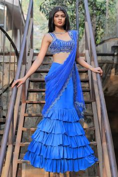 Blue ruffle mermaid skirt saree with a detachable drape, an attached cancan and mirror, beads and thread hand embroidered borders. Comes with a padded blouse. - Aza Fashions Blue Fitted Draped Lehenga, Fitted Draped Blue Lehenga, Blue Georgette Dresses With Ruffles, Blue Ruffled Pre-draped Saree For Party, Blue Georgette Lehenga With Ruffles, Blue Lehenga With Ruffles And Traditional Drape, Blue Ruffled Lehenga For Festive Occasions, Blue Lehenga With Ruffles For Wedding, Blue Ruffled Lehenga For Wedding