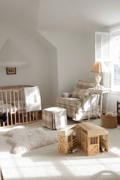 a baby's room with white walls and furniture