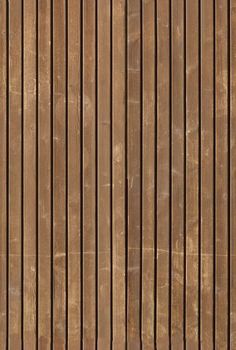 a brown wooden wall with vertical lines painted on the side and wood slats at the bottom