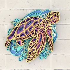 an intricate cutout of a sea turtle on a white brick wall