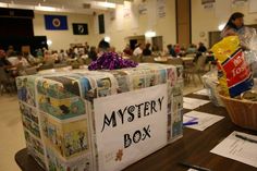 the mystery box is on display at the library's book signing event, with people in the background